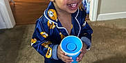 Genesis joined the competition — help win amazing prizes! toddler, child, pajamas, blue, cup, smiling, indoor, carpet, barefoot, water_bottles, doorway, happy, clothing, person, floor, home, young_child, cute, standing, portrait