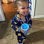 toddler, child, pajamas, blue, cup, smiling, indoor, carpet, barefoot, water_bottles, doorway, happy, clothing, person, floor, home, young_child, cute, standing, portrait