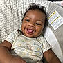 Adrien joined the competition — help win amazing prizes! baby, child, smiling, curly_hair, drool, tongue_out, infant, baby_seat, patterned_fabric, blue_toy, happy, cute, indoor, closeup, person, young_child, casual_clothing, playful, joyful, portrait