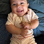 Ada joined the competition — help win amazing prizes! baby, smiling, infant, jewelry, bracelet, necklace, clothing, heart_pattern, lying_down, blanket, cute, happy, portrait, skin, face, hand, baby_girl, indoor, comfort, soft