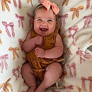 Avilyn is registered to the contest to win money with this photo: baby, smiling, bow, blanket, cute, infant, happy, cozy, clothing, headband, child, soft, pattern, cute_baby, portrait, sitting, skin, flesh_tone, infancy, warm