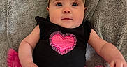 Avilyn joined the competition — help win amazing prizes! baby, infant, black_bow, headband, pink_skirt, tutu, black_top, heart_design, blanket, soft_texture, cute, child, portrait, indoors, clothing, smiling, sitting, person, young, adorable