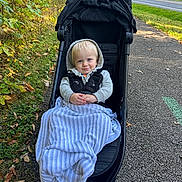 Ayden joined the competition — help win amazing prizes! toddler, child, stroller, blanket, hoodie, outdoor, path, autumn, foliage, smile, pavement, nature, leaves, trees, daylight, baby, person, cute, park, walkway