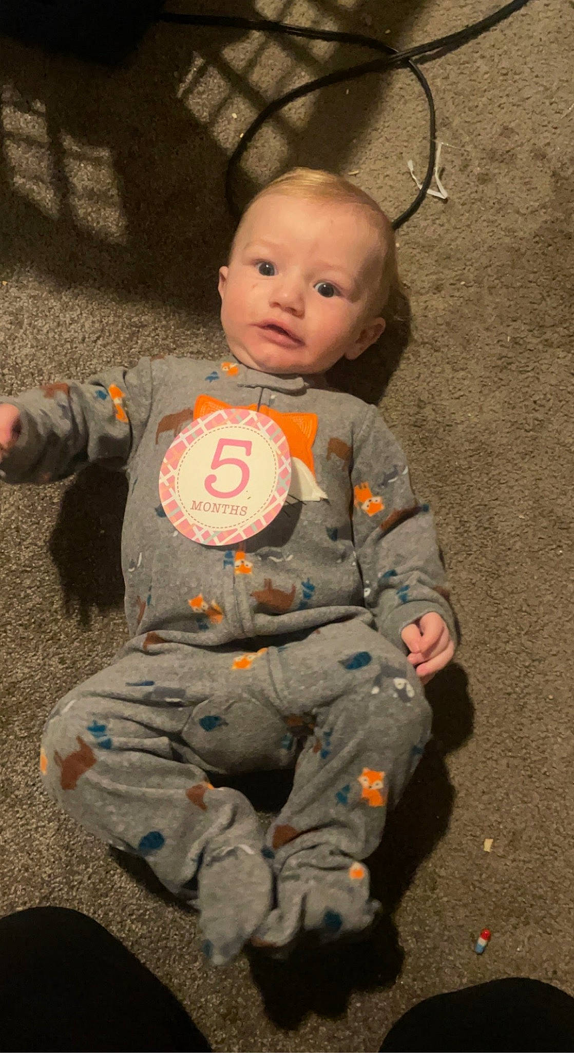 Liam is registered to the contest to win money with this photo: baby, baby_toddler_clothing, cheek, child, denim, eye, face, fun, hair, hairstyle, head, pattern, person, play, sitting, skin, sleeve, t_shirt, toddler, uniform