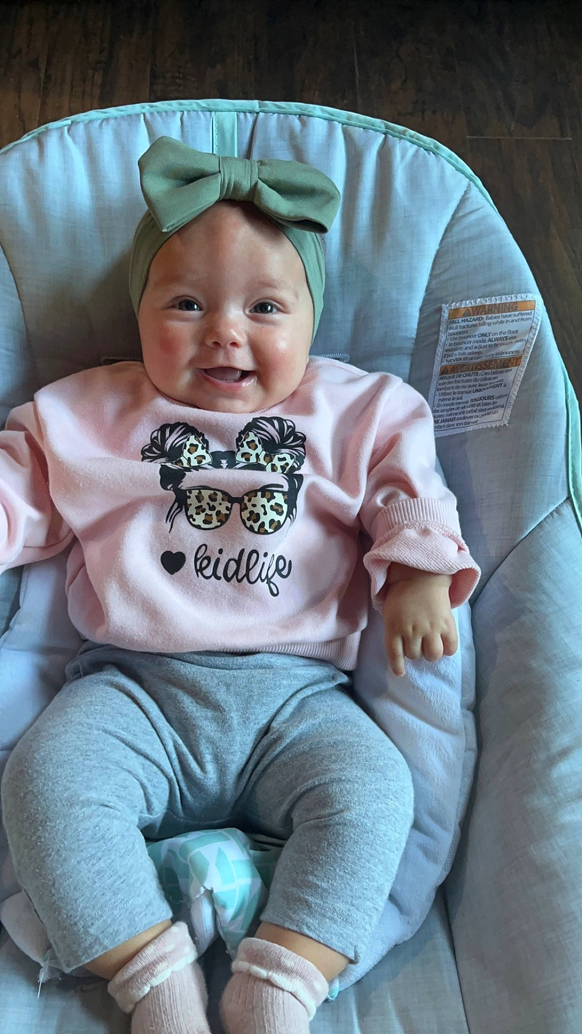 Everlee joined the competition — help win amazing prizes! baby, baby_products, baby_toddler_clothing, child, comfort, eye, face, grass, grey, happy, head, headwear, human_body, joy, person, pink, sitting, skin, sleeve, smile