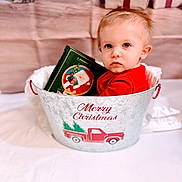 Damon joined the competition — help win amazing prizes! toddler, child, baby, bucket, christmas, holiday, gift, present, red_clothing, book, indoor, festive, decorations, face, portrait, cute, holiday_season, winter, smile, sitting