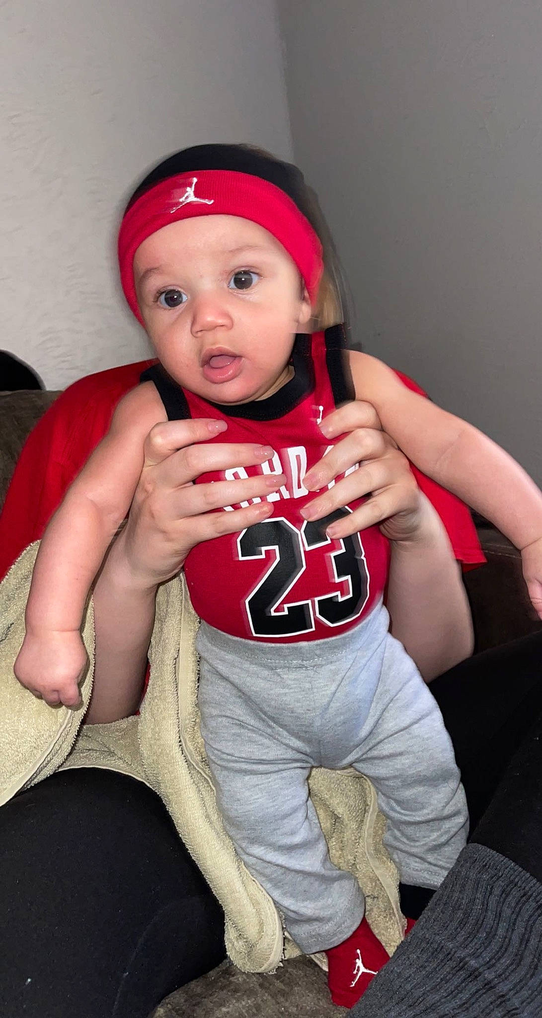 Liam is registered to the contest to win money with this photo: arm, baby, baby_toddler_clothing, cap, comfort, cool, elbow, eye, eyebrow, finger, flash_photography, gesture, hand, headwear, human_body, joint, knee, lip, muscle, person