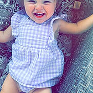 Presley joined the competition — help win amazing prizes! toddler, child, smiling, dress, bow, cushion, wicker_chair, patterned, happy, cute, indoors, portrait, baby, seat, clothing, person, face, cheerful, playful, young