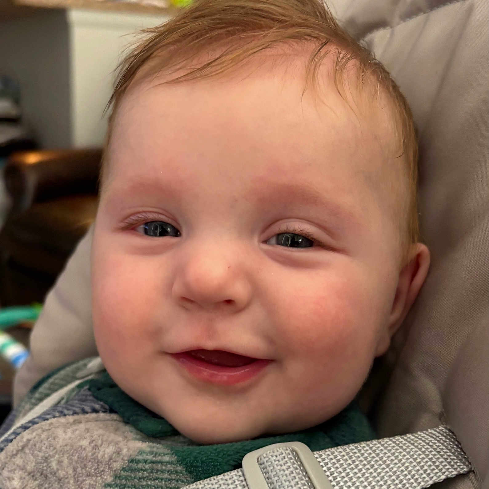 Elyon is registered to the contest to win money with this photo: baby, cheeks, child, close_up, comfortable, cute, expressive, eyes, face, hair, happy, indoor, infant, person, portrait, seatbelt, skin, smiling, straps, young_child