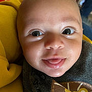Kaedyn joined the competition — help win amazing prizes! baby, close_up, smiling, tongue_out, face, eyes, infant, yellow_blanket, clothing, lion_patch, cute, child, portrait, soft_light, indoor, person, skin, head, happy, young