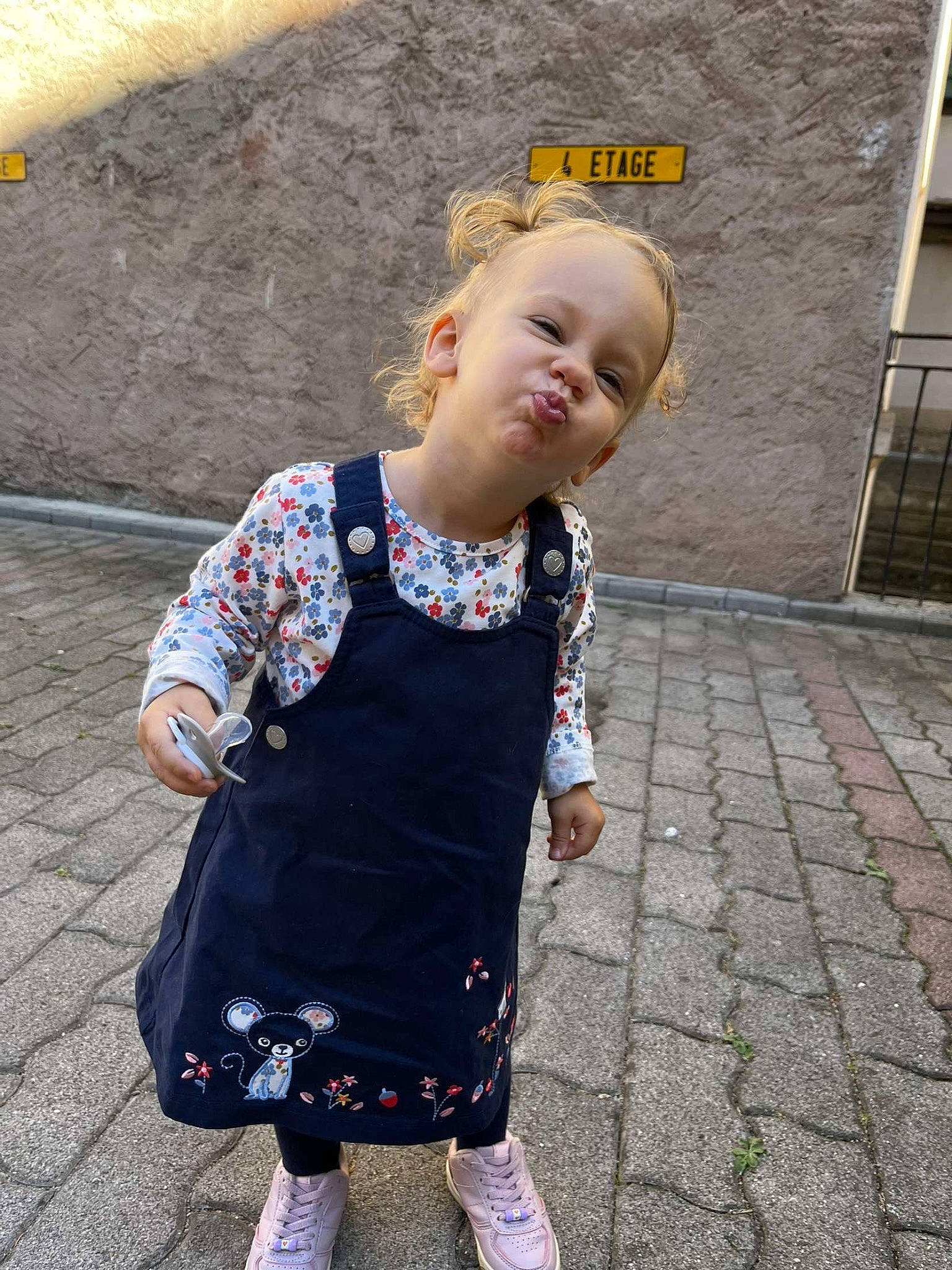 Tiana participe au concours pour gagner de l'argent avec cette photo : asphalt, baby, baby_toddler_clothing, child, day_dress, flooring, fun, grass, happy, magenta, pattern, person, road_surface, sidewalk, sleeve, smile, sock, t_shirt, toddler, vacation
