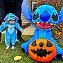 Grayson joined the competition — help win amazing prizes! baby, child, toddler, costume, blue, stitch, inflatable, pumpkin, halloween, grass, autumn, leaves, person, hands, shoes, house, sidewalk, outdoor, holiday, cute