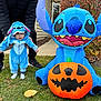 Grayson joined the competition — help win amazing prizes! toddler, child, baby, blue_onesie, costume, halloween, inflatable, pumpkin, grass, fall_leaves, adult_hands, outdoor, house, sidewalk, shoes, black_pants, cute, holiday, celebration, person