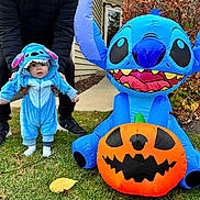 Grayson joined the competition — help win amazing prizes! baby, child, toddler, costume, blue, inflatable, pumpkin, halloween, grass, outdoor, person, adult, shoes, fall, leaves, cute, holiday, celebration, fun, portrait
