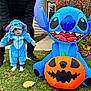 baby, child, toddler, costume, blue, inflatable, pumpkin, halloween, grass, outdoor, person, adult, shoes, fall, leaves, cute, holiday, celebration, fun, portrait