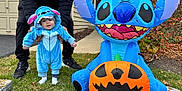 Grayson is registered to the contest to win money with this photo: baby, child, costume, blue, inflatable, pumpkin, halloween, grass, adult, support, outdoor, house, holiday, cute, smiling, celebration, fall, leaves, footwear, person
