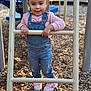 Ashanti joined the competition — help win amazing prizes! toddler, child, playground, ladder, overalls, pink_sweater, shoes, wood_chips, outdoor, daylight, curly_hair, smiling, person, casual_clothing, play, fun, young_child, happy, holding, denim