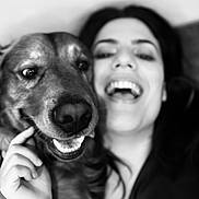 Spritz is registered to the contest to win money with this photo: dog, woman, person, selfie, portrait, black_and_white, smiling, laughing, happy, face, human, pet, companion, close_up, indoors, hand, teeth, nose, fur, photography