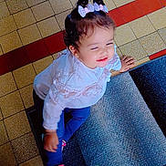 Abidi Amira a rejoint le concours — aidez-le/la à gagner de superbes lots ! toddler, child, smiling, hair_bows, pink_shoes, white_top, floor_tiles, carpet, indoor, playful, happy, person, young_child, cute, candid, motion, patterned_floor, sitting, baby, casual_clothing