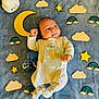 baby, infant, one_month_old, blanket, wooden_stars, wooden_clouds, wooden_rainbows, crocheted_toy, octopus, cute, smiling, lying_down, soft_toys, child, newborn, indoors, colorful, happy, playful, portrait
