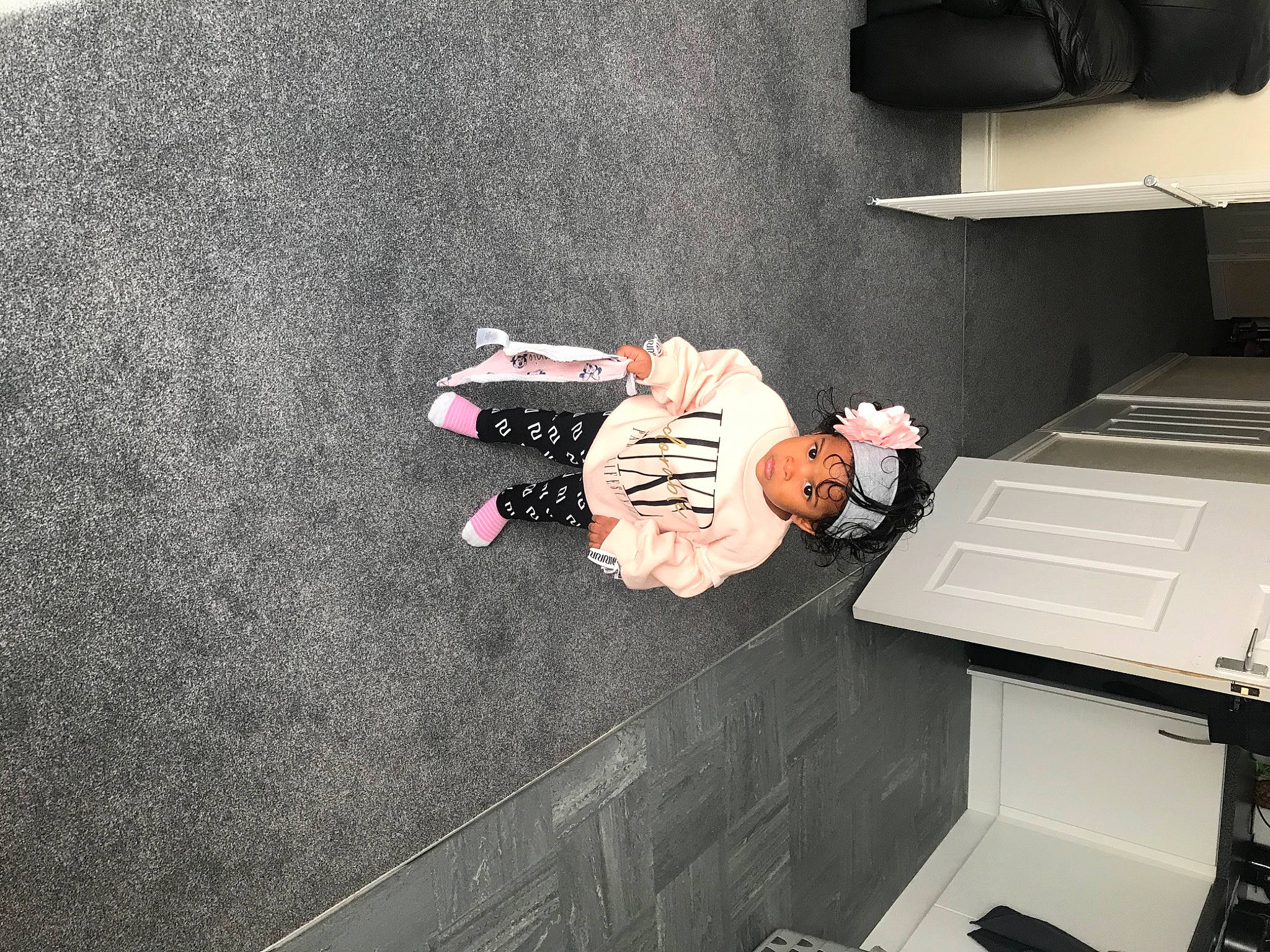 Amiah is registered to the contest to win money with this photo: floor, flooring, headwear, material_property, person, room, shoe, tile, wall