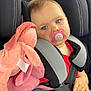 Lüna a rejoint le concours — aidez-le/la à gagner de superbes lots ! child, baby, car_seat, pacifier, plush_toy, pink, blue_eyes, seatbelt, red_clothing, denim, hand, sitting, comfort, soft_toy, infant, cute, indoors, safety, closeup, portrait