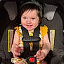Zaiori is registered to the contest to win money with this photo: toddler, child, car_seat, safety_harness, smiling, blue_eyes, headband, yellow_clothing, floral_pattern, baby, indoor, person, seat, happy, cute, infant, young_child, hands, legs, bright