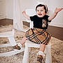 toddler, child, smiling, sitting, chair, plaid, skirt, shoes, headband, carpet, indoor, white, furniture, happy, cute, person, fashion, rocking_horse, room, playful