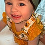 toddler, child, smiling, blue_eyes, headband, sunflower_pattern, yellow_clothing, crawling, happy, cute, baby, portrait, indoor, closeup, person, infant, skin, face, hand, young_child
