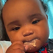 Kashton joined the competition — help win amazing prizes! baby, child, face, hand, food, messy, spiderman, clothing, closeup, curly_hair, indoor, portrait, cute, snack, eating, expression, person, young_child, skin, background