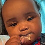 baby, child, face, hand, food, messy, spiderman, clothing, closeup, curly_hair, indoor, portrait, cute, snack, eating, expression, person, young_child, skin, background