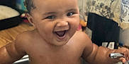 Kashton is registered to the contest to win money with this photo: baby, sink, water, smiling, happy, faucet, bath, child, indoor, curtain, kitchen, cute, toddler, bare_chest, joyful, face, person, sitting, fun, playful