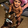 Kashton joined the competition — help win amazing prizes! baby, child, pink_hat, cowboy_hat, plush_toy, rocking_horse, indoor, carpet, couch, socks, smiling, happy, person, toy, hand, furniture, cute, play, support, young_child