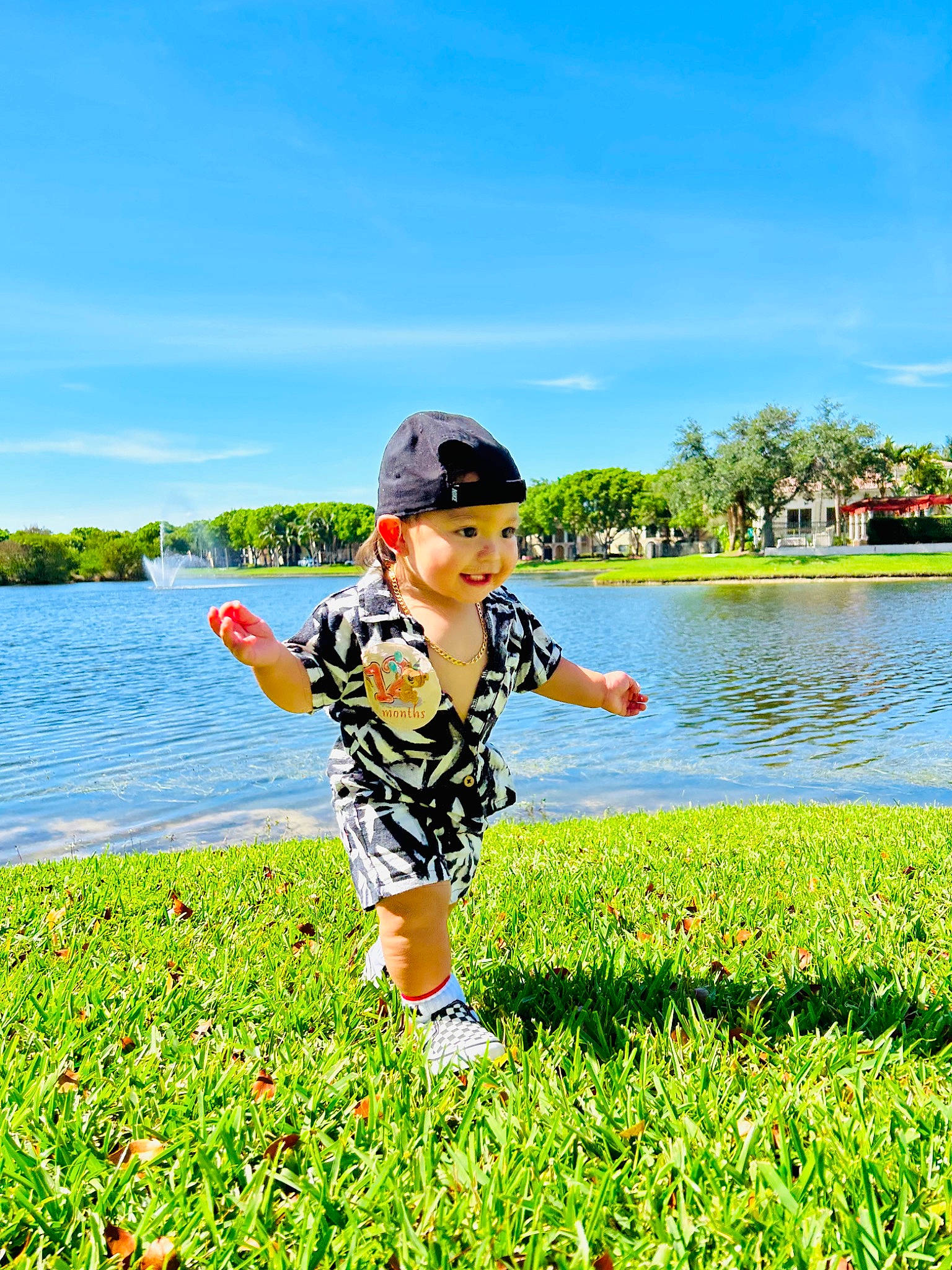 Aaron is registered to the contest to win money with this photo: bank, cloud, grass, grassland, happy, headwear, joy, lake, landscape, leisure, meadow, natural_environment, natural_landscape, outdoor_recreation, people_in_nature, person, plant, recreation, sky, summer
