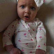 Salem joined the competition — help win amazing prizes! baby, child, onesie, headwear, bow, cherry_pattern, expression, face, hand, sitting, indoors, clothing, infant, cute, portrait, skin, person, young, wide_eyes, curious