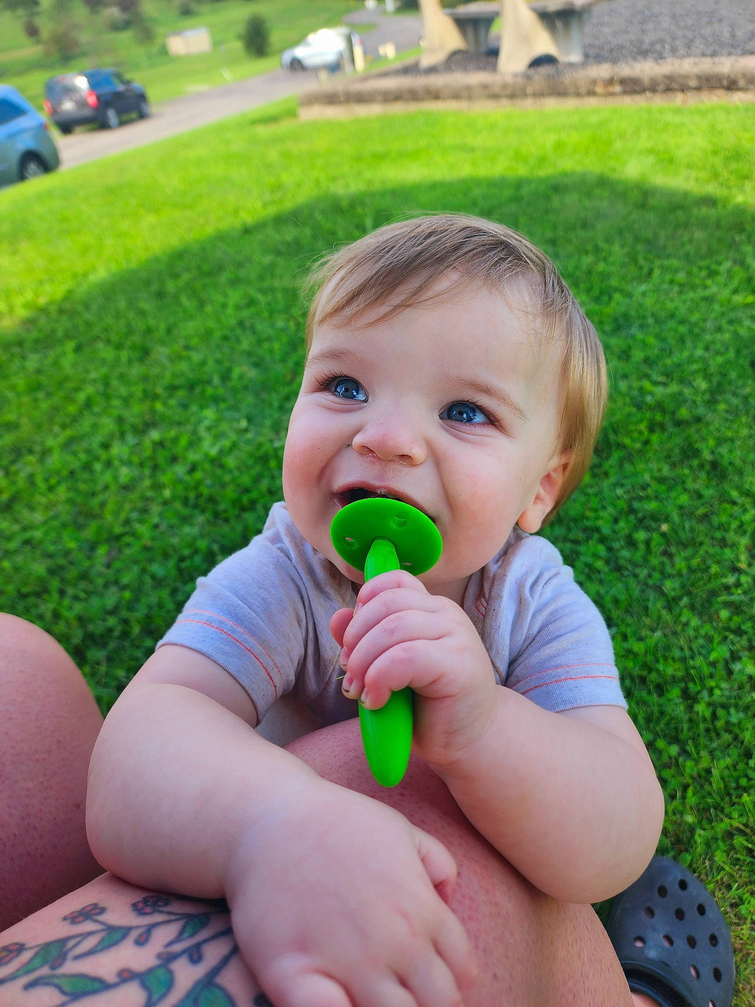 Ryland is registered to the contest to win money with this photo: baby, baby_toddler_clothing, biting, cheek, child, finger, fun, gesture, grass, green, happy, leisure, lip, mouth, nose, people_in_nature, person, plant, summer, thumb