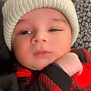 Farhan joined the competition — help win amazing prizes! baby, black_clothing, checkered_pattern, child, closeup, cozy, cute, expression, face, hand, hat, indoors, infant, knit_hat, penguin_patch, portrait, red_clothing, skin, warm_clothing, young_child