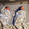 newborn, baby, sleeping, blanket, crib, pacifier, sheep_pattern, twins, infant, sleep, cozy, bed, yellow, floral_pattern, soft, wrapped, cute, peaceful, indoor, person