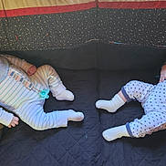 Lukah And Landon joined the competition — help win amazing prizes! baby, infant, child, onesie, bib, pillow, blanket, cushion, patterned_clothing, indoor, lying_down, cute, two_babies, face, sock, soft_lighting, portrait, resting, toddler, curious