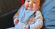 Lukah And Landon joined the competition — help win amazing prizes! baby, infant, pacifier, onesie, bib, couch, pillow, quilt, star_pattern, child, indoor, relaxed, plush, smiling, cute, comfortable, clothing, person, portrait, home