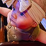 adorable, baby, baby_clothing, bib, child, close_up, colorful, face, fashion, headband, highchair, indoor, infant, large_bow, portrait, restaurant, seated, smiling, warm_lighting, wide_eyed