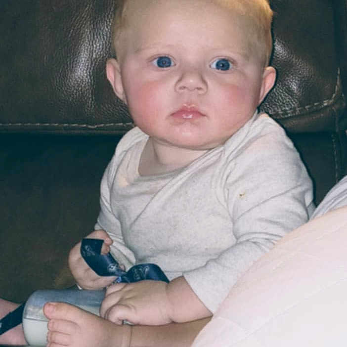 Louie joined the competition — help win amazing prizes! baby, blue_eyes, casual, child, clothing, curious, cute, expression, face, foot, hand, home, indoor, infant, leather_couch, person, portrait, sitting, skin, young_child