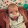 Gracie joined the competition — help win amazing prizes! baby, infant, oxygen_tube, medical_equipment, blanket, floral_pattern, clothing, raised_hands, hospital, lying_down, face, person, newborn, healthcare, nasal_cannula, bed, soft_texture, indoors, expression, cute