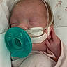 Gracie is registered to the contest to win money with this photo: newborn, baby, infant, pacifier, blanket, sleeping, medical_tubes, face, wrapped, soft, cozy, indoors, child, person, resting, cute, peaceful, hospital, healthcare, bed