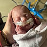 newborn, baby, infant, sleeping, blanket, hand, hospital, medical_tubes, care, person, healthcare, equipment, closeup, wrapped, soft, peaceful, rest, tiny, pediatric, neonatal