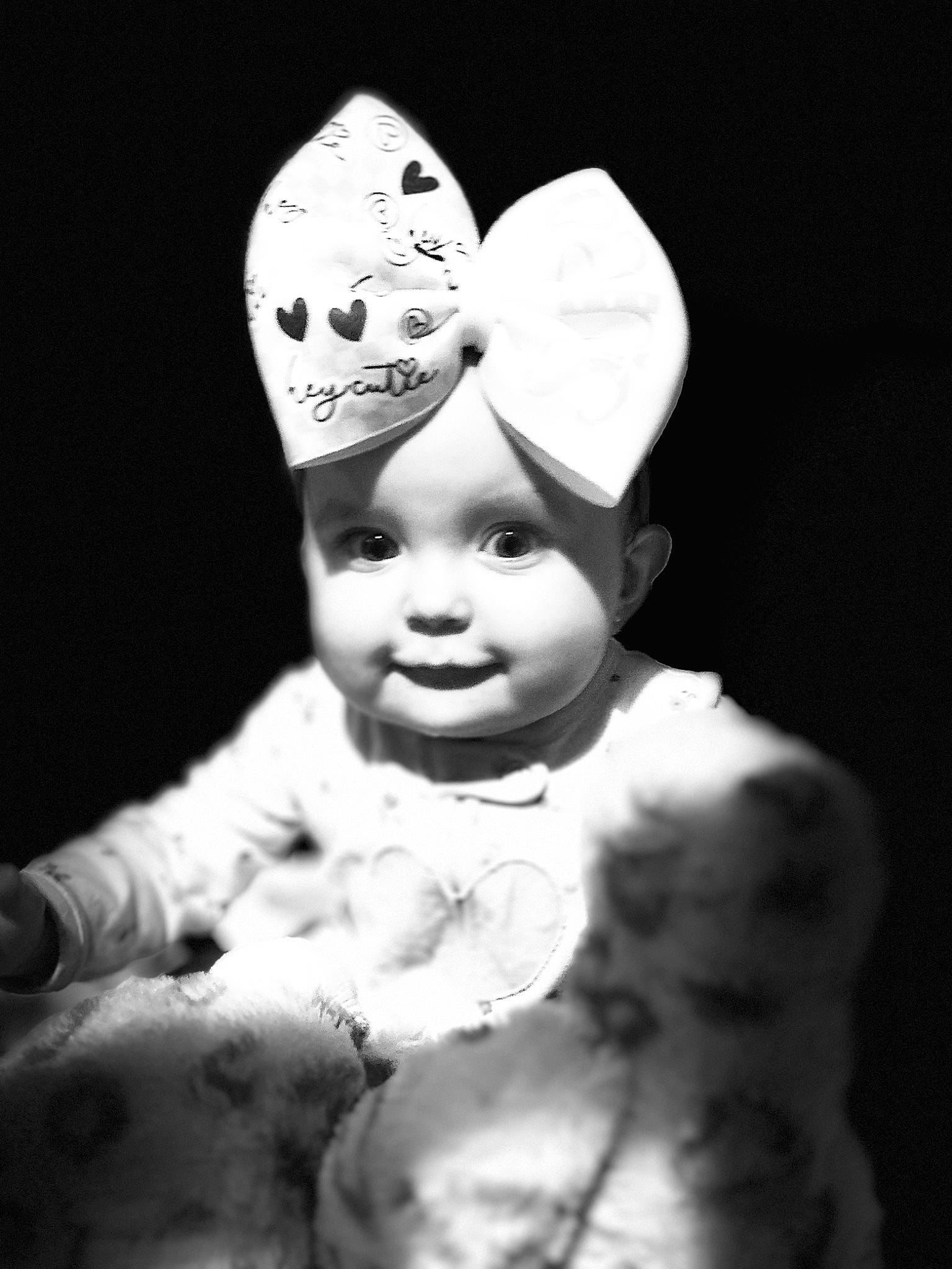 Paris is registered to the contest to win money with this photo: art, baby, cap, child, costume_hat, event, fashion_accessory, flash_photography, hair_accessory, happy, hat, headgear, headpiece, headwear, jewellery, monochrome, monochrome_photography, person, still_life_photography, toddler