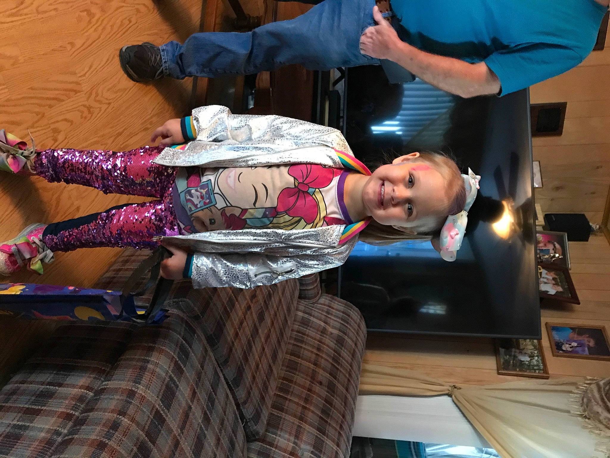 Mariah is registered to the contest to win money with this photo: abdomen, elbow, human_leg, joy, lap, person, plaid, sandal, tartan, trunk, wrist