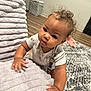 Braelynn joined the competition — help win amazing prizes! baby, child, curly_hair, indoor, blanket, cushion, carpet, floor, wood_floor, basket, clothing, cute, face, hands, person, toddler, expression, home, soft_texture, curiosity