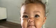 Braelynn joined the competition — help win amazing prizes! child, toddler, indoor, pink_shirt, face, expression, curly_hair, floor, wall, playful, person, young_child, baby, cute, infant, portrait, clothing, skin, head, eyes