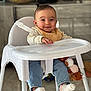 Talia participe au concours pour gagner de l'argent avec cette photo : baby, high_chair, bib, smiling, indoor, plush_toy, jeans, socks, child, person, furniture, kitchen, table, seat, cute, happy, infant, young_child, face, portrait